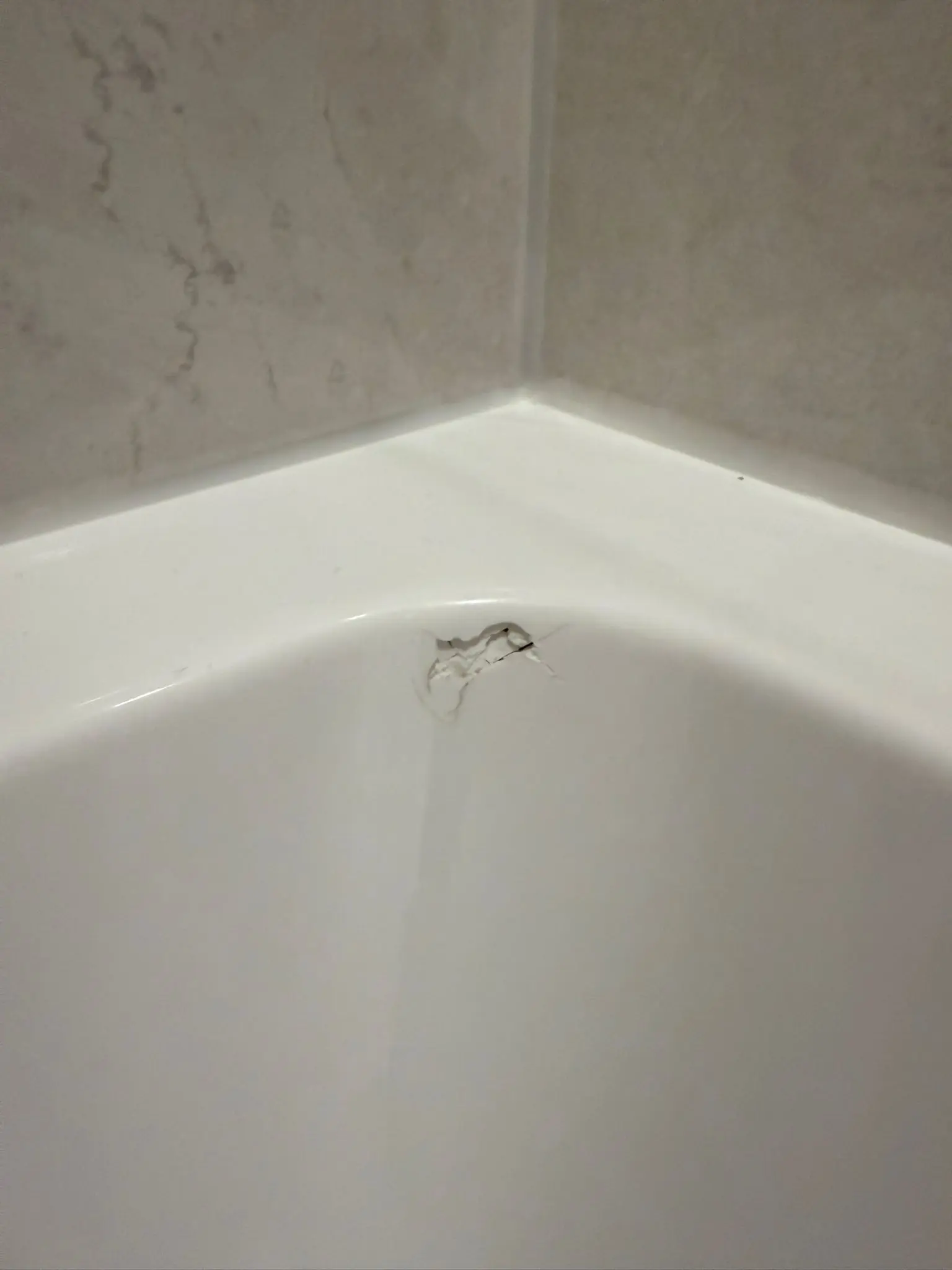 Drill hole in tile before repair